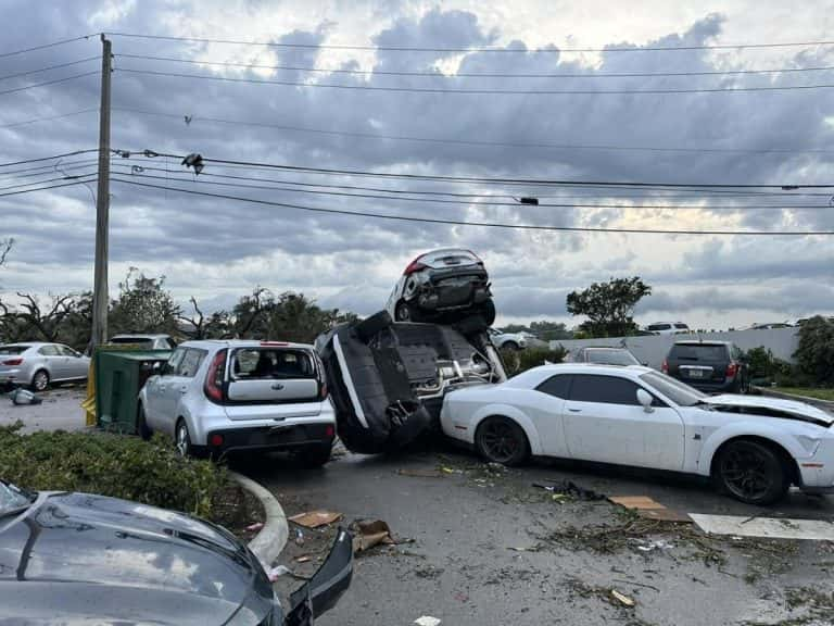 In South Florida, a tornado touches down and flips automobiles, and knocks down trees