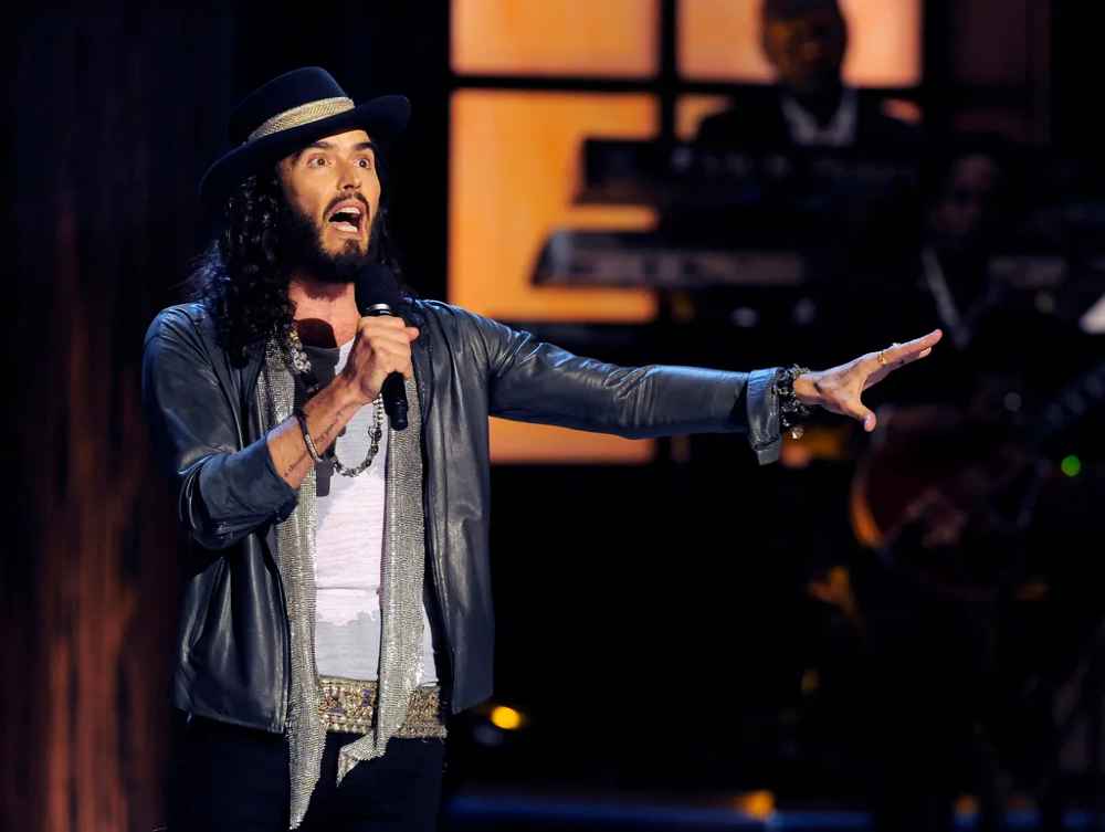 English Comedian Russell Brand Returns to Stage Amidst Allegations; Investigations Underway