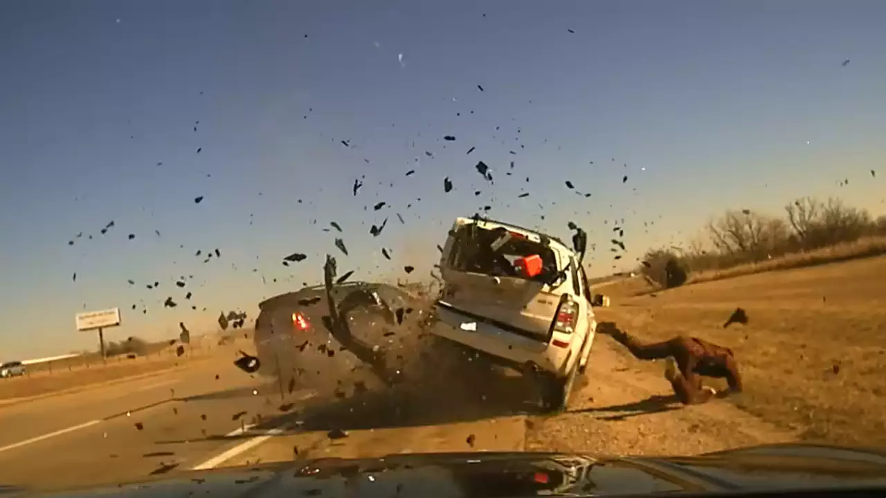 After stopping for a car on the freeway, an Oklahoma officer was roughly shoved to the ground